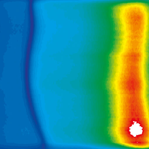 Photoluminescence measurements in fields up to 28 T made with cryogenic positioners