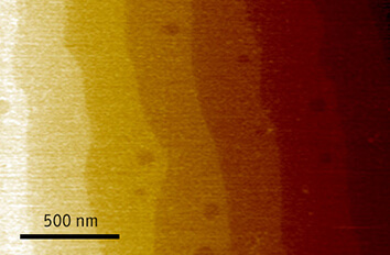 In situ AFM measurements of SrTiO3 and Co particles inside an electron microscope made with cryogenic scanning probe microscope attoAFM III