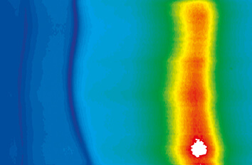 Photoluminescence measurements in fields up to 28 T made with cryogenic positioners